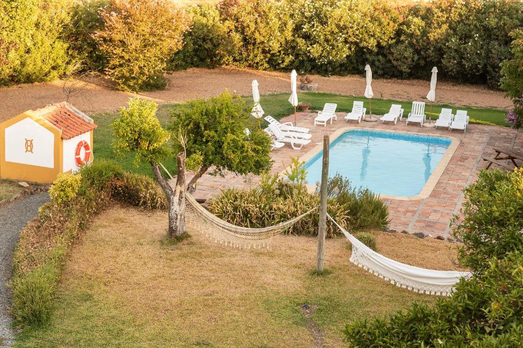 an aerial view of a pool with hammocks and a house at Herdade da Ordem in Cabeço de Vide