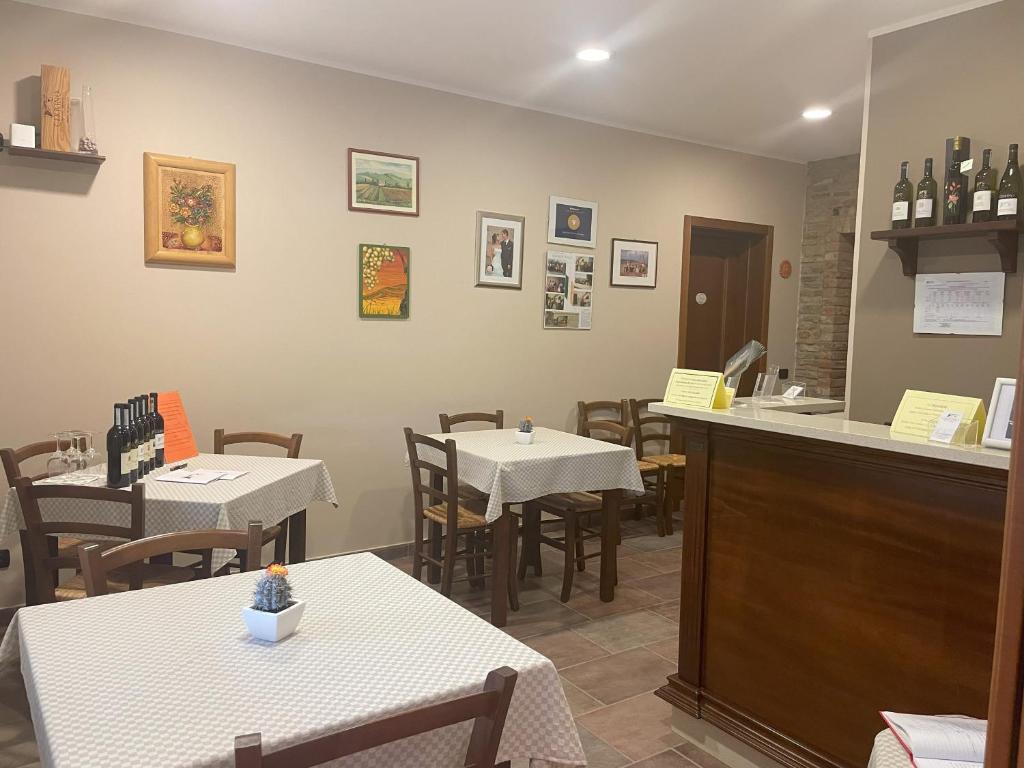 a restaurant with tables and chairs and a counter at Agriturismo Finestre di Langa in Trezzo Tinella