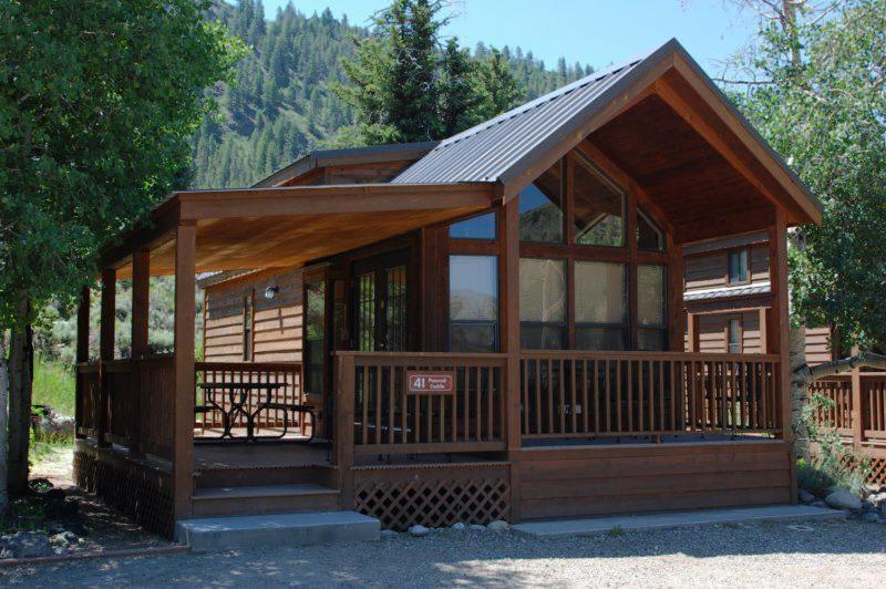 a large wooden cabin with a large window at Cabin 41 in Almont