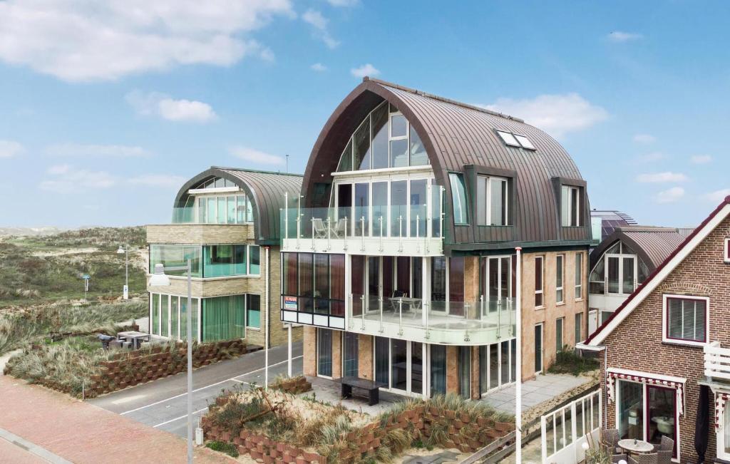an architectural rendering of a building with a metal roof at Flat Fish in Egmond aan Zee