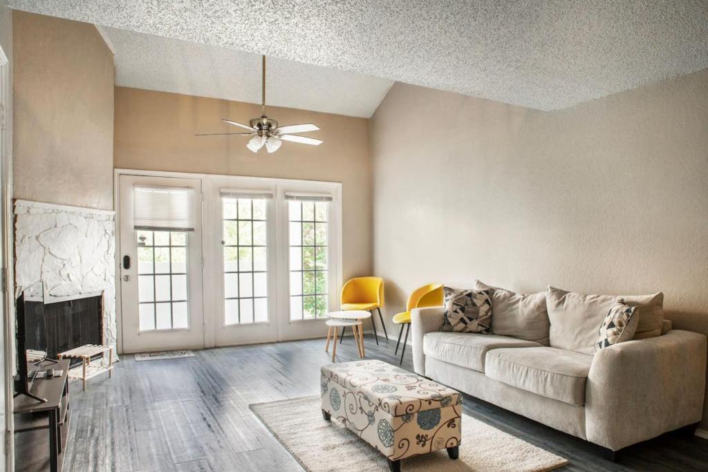 a living room with a couch and a table at Extended Stay Special Cozy Apt w Private Garage in Dallas
