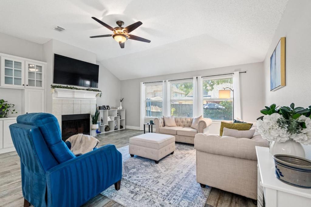 un salon avec un canapé et un ventilateur de plafond dans l'établissement Extended Stay Fun Outdoor Games, Gym, BBQ, Dining, à Lewisville