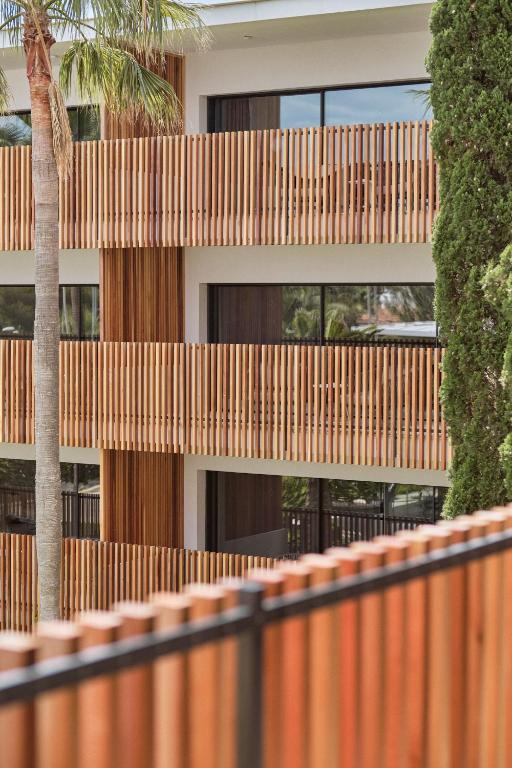 a wooden fence in front of a building at Las Gaviotas Suites Hotel & Spa in Playa de Muro