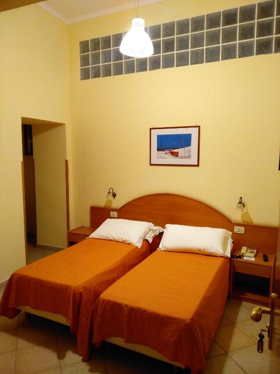 Postel nebo postele na pokoji v ubytování Hotel Del Corso