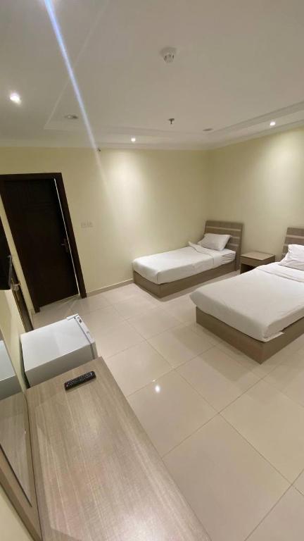 Postel nebo postele na pokoji v ubytování Al tawfeeg hotel - Al Azizyah