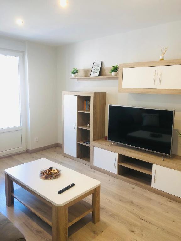 a living room with a tv and a coffee table at Apartamento Casablanca in Potes