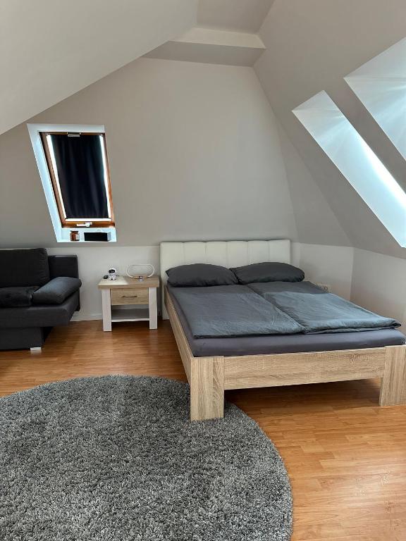 a bedroom with a bed and a couch and a tv at Q2 Apartment Hannover Döhren mit Ausblick in Hannover