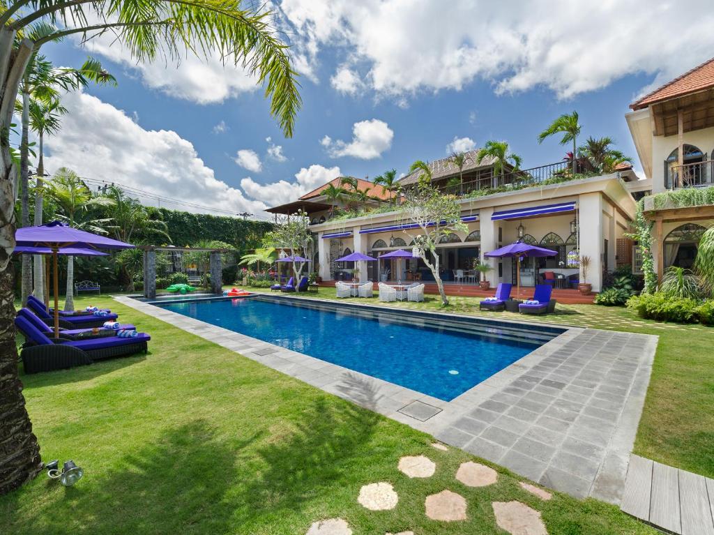 an exterior view of a house with a swimming pool at Sayang d'Amour in Seminyak