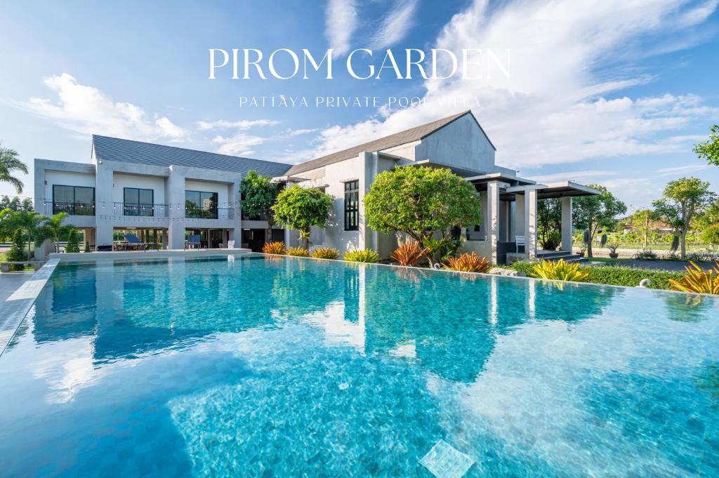 a large swimming pool in front of a building at Pirom Garden Private Villa in North Pattaya