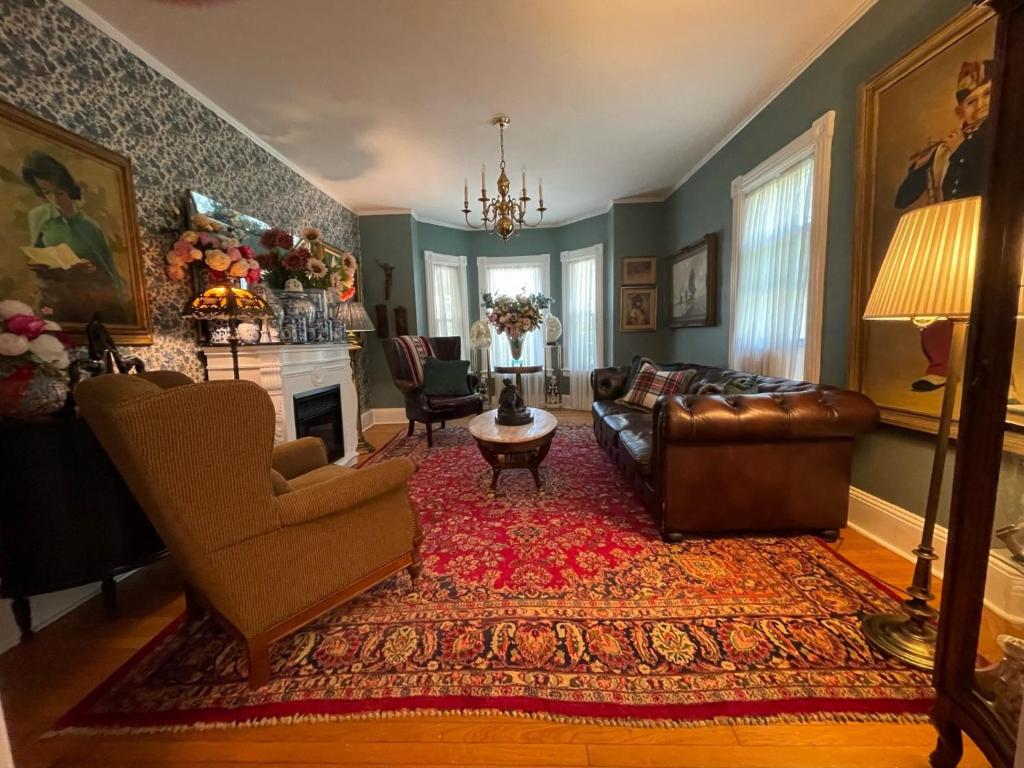 a living room with a couch and a fireplace at Beacon Hermitage in Beacon