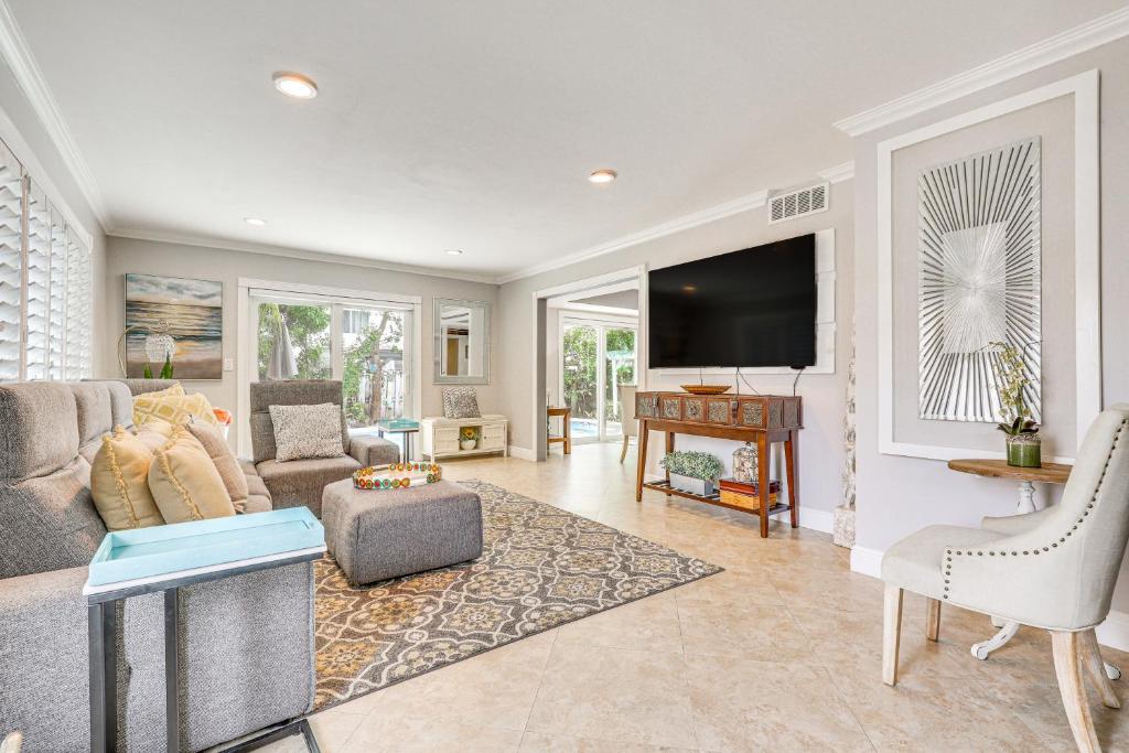 a living room with a couch and a tv at Sun-Soaked Pompano Beach Home with Private Pool! in Pompano Beach