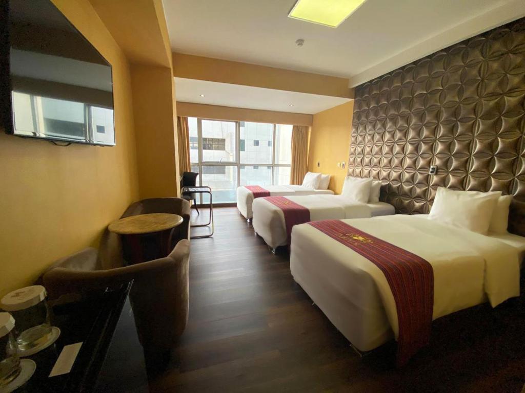 Voodi või voodid majutusasutuse Luxury Inkari Hotel toas