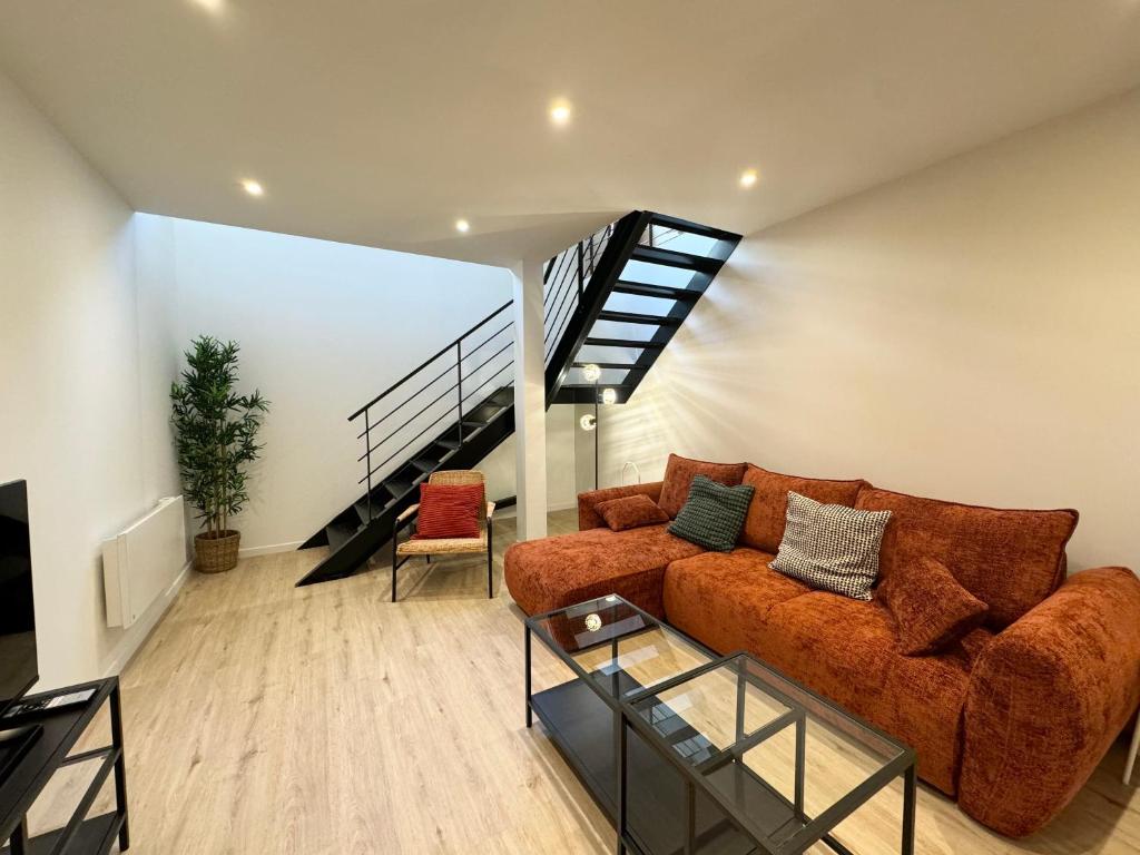 un salon avec un canapé et un escalier dans l'établissement Appartement Cosy en Centre-Ville, à Brest