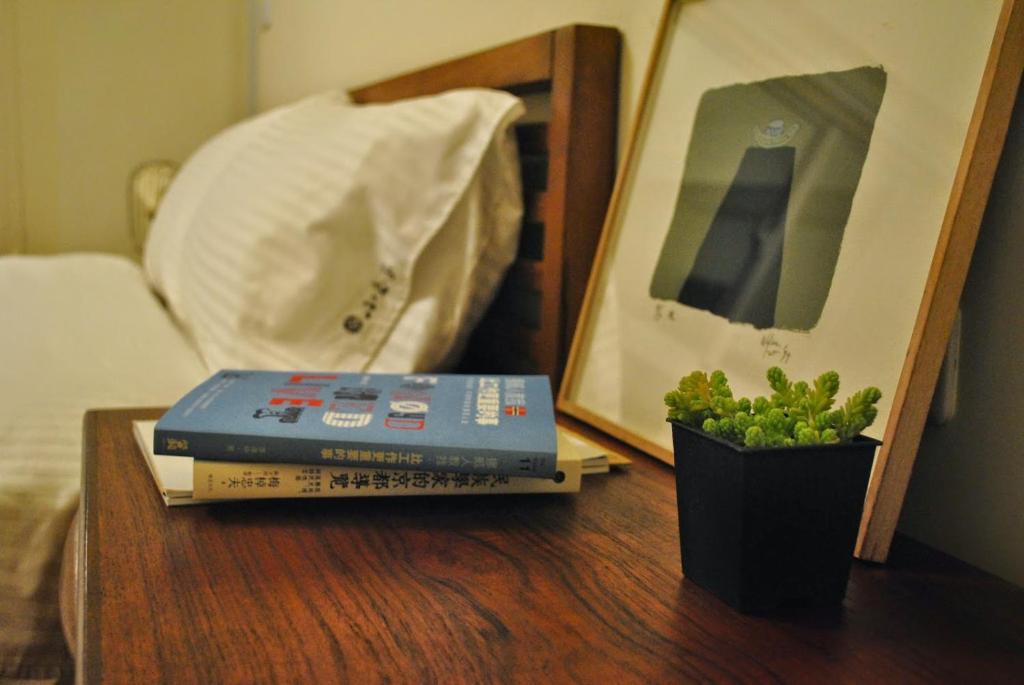 台東市的住宿－小春家，一张桌子,上面有两本书和一株盆栽植物