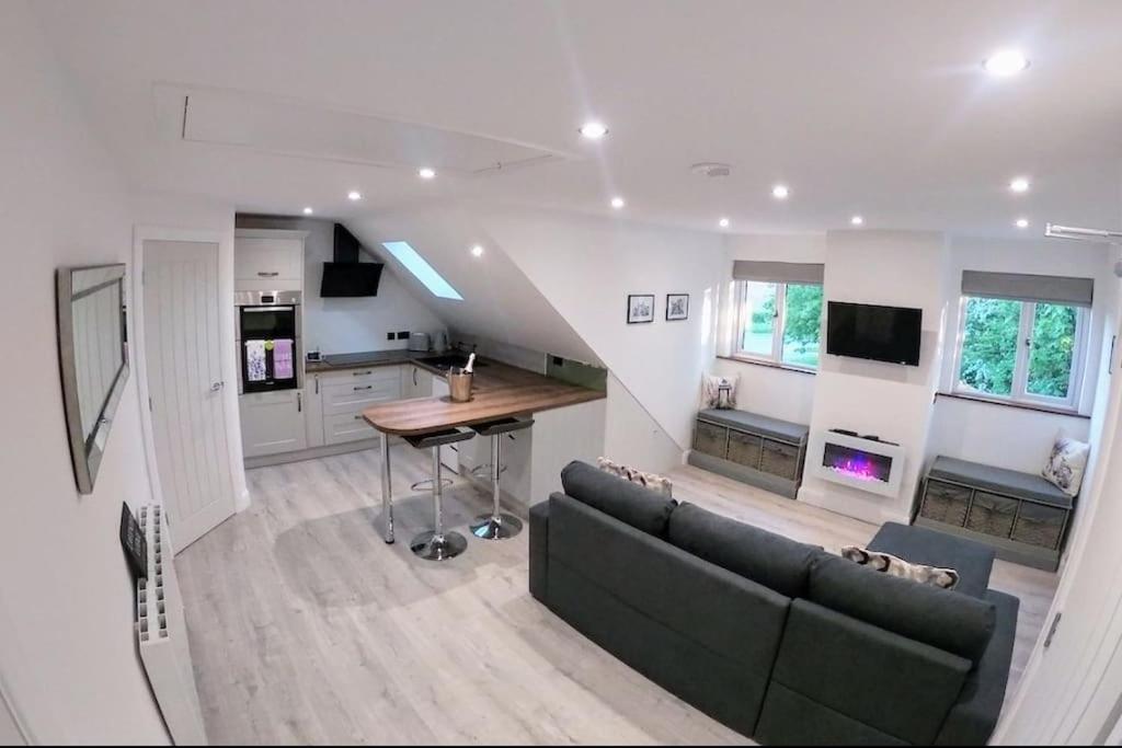 a living room with a couch and a table at Lavender Lodge - Modern apartment in York in Copmanthorpe