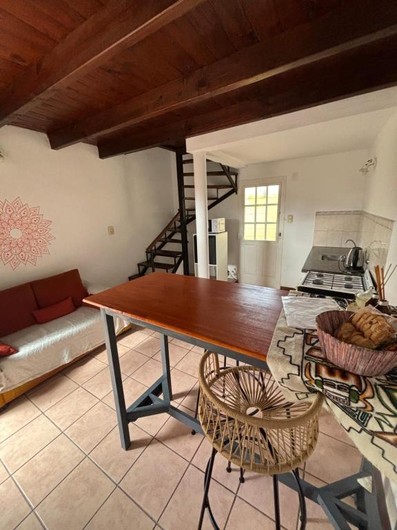 a living room with a wooden table and a couch at Complejo Alberdi depto 8 in Tandil