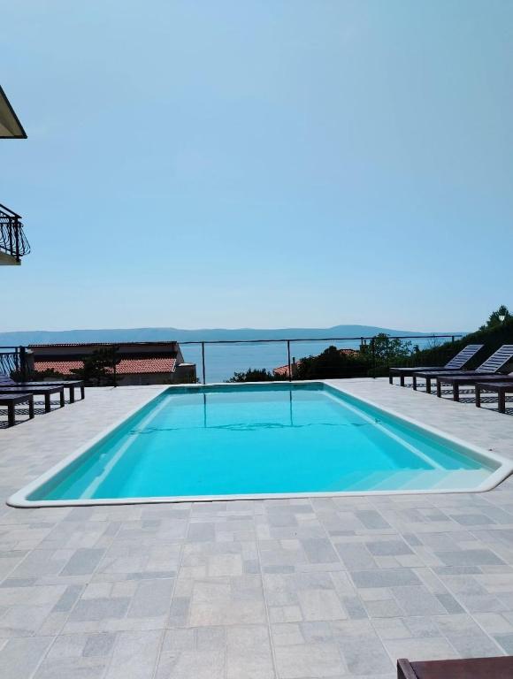 a swimming pool with a view of the ocean at Island view 1 in Novi Vinodolski