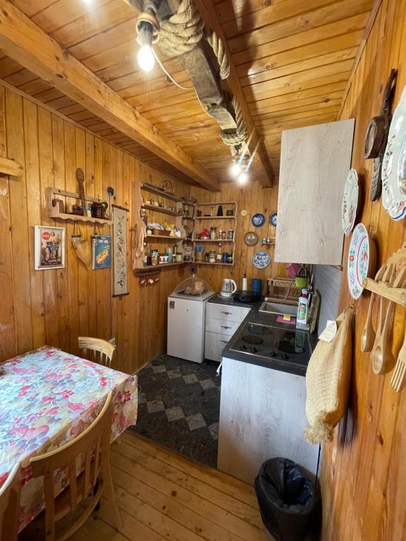a kitchen with a table and a stove and a table and a table sidx sidx at Vikendica Malović in Žabljak