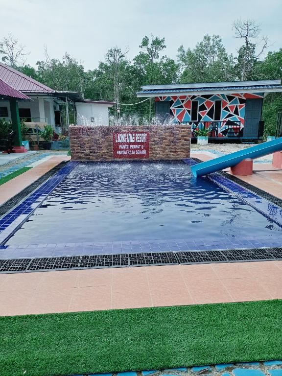 a pool at a resort with a water slide at Lading Amas Resort in Rengit