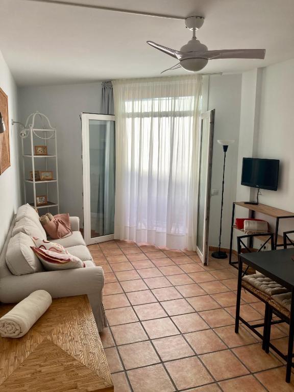 a living room with a couch and a table at EL PATIO De Arguineguìn in Arguineguín