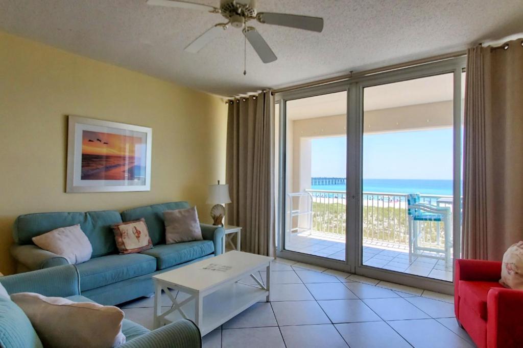 a living room with a couch and a view of the ocean at Navarre Beach Regency 203 in Navarre