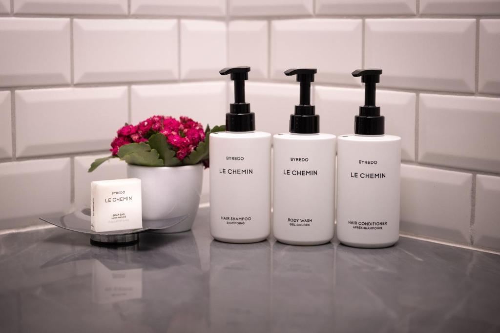 a group of four bottles of detergents on a counter at Hotel Maria Cristina, a Luxury Collection Hotel, San Sebastian in Donostia-San Sebastián