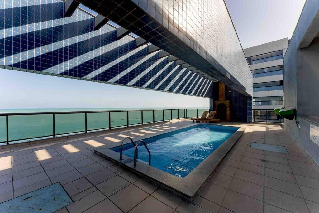 a swimming pool on the roof of a building at O EDIFÍCIO é de frente ao MAR de Pajuçara NEO 2 Qts 2gar - Adm Nutelss in Maceió