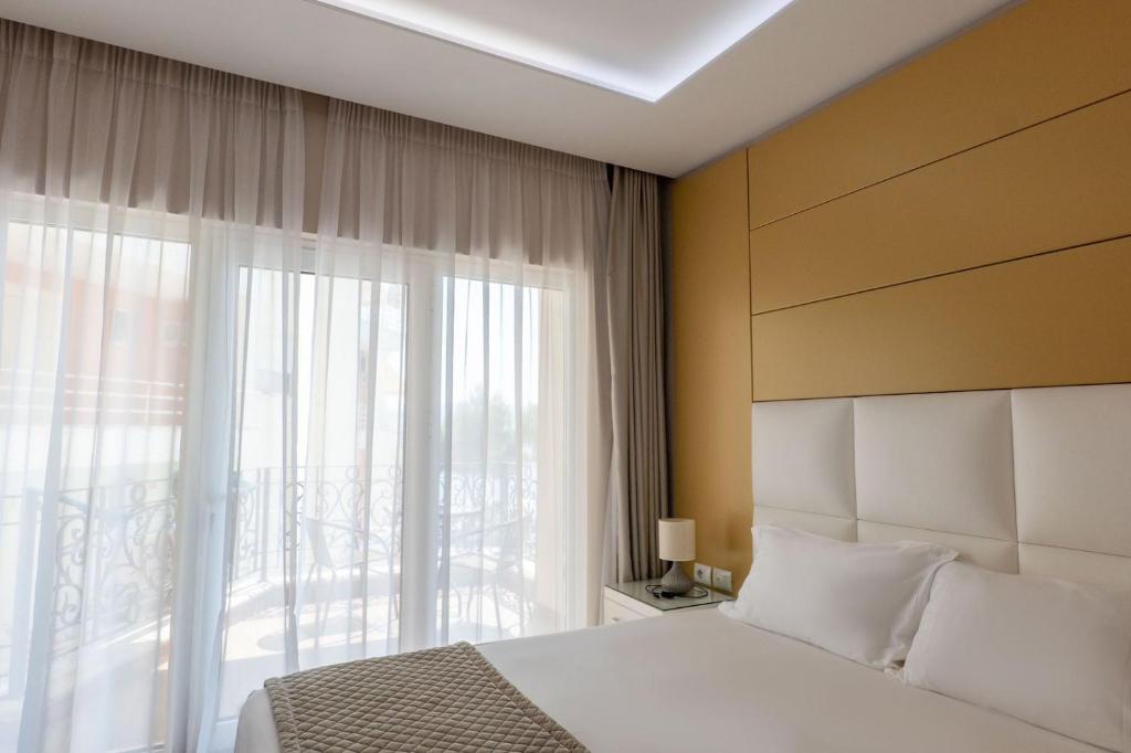 Postel nebo postele na pokoji v ubytování AMI MAR Hotel