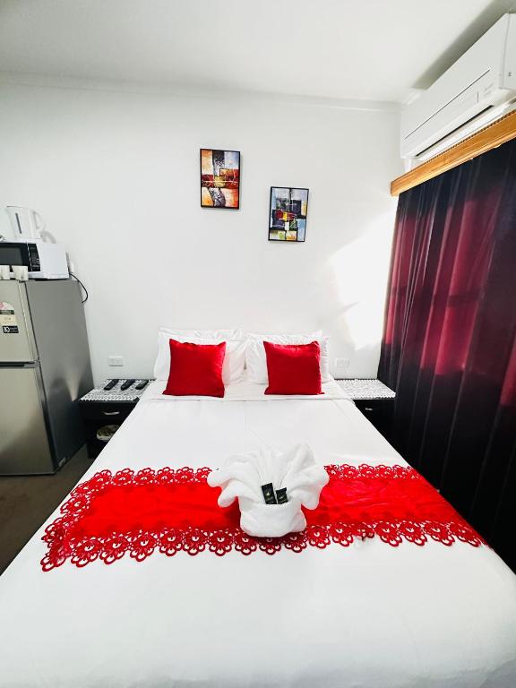 Postel nebo postele na pokoji v ubytování Harrison Motel Papatoetoe