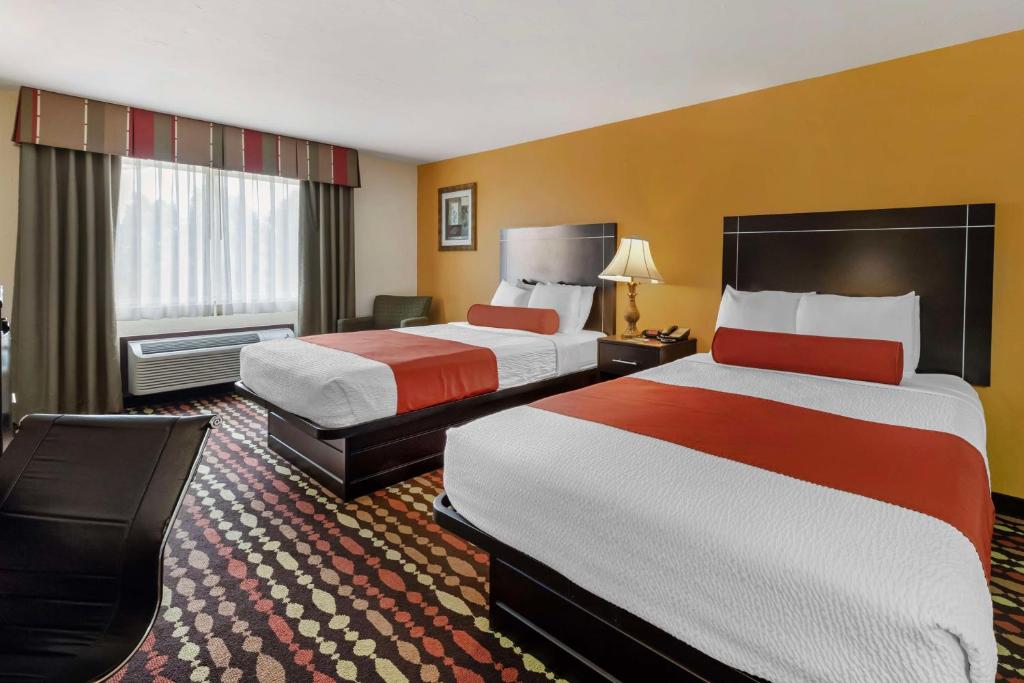 a hotel room with two beds and a large window at Best Western Greentree Inn & Suites in Moore