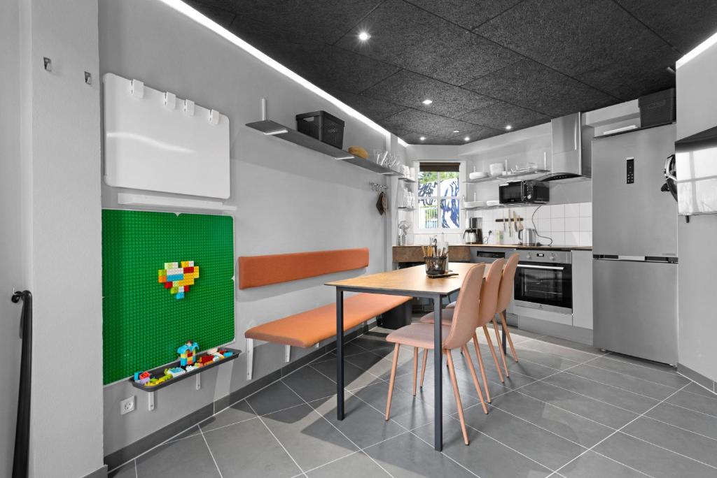 a kitchen with a table and some chairs and a tableablish at Rent A Holiday Apartment At Fun Art And Stay In A Mecca Of Art And Experiences!  in Pandrup
