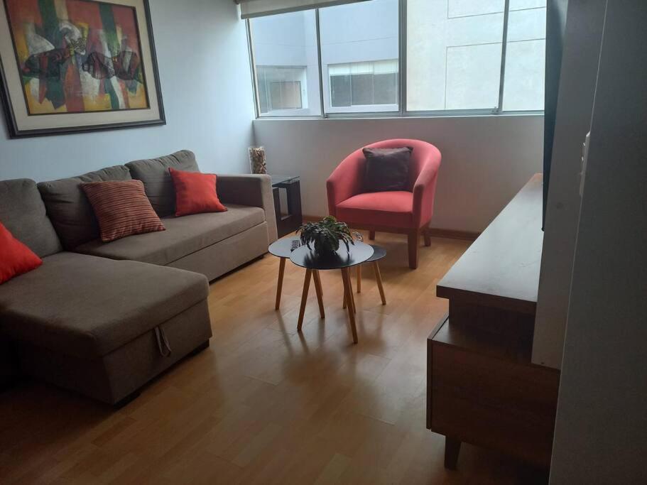 a living room with a couch and a chair at Depa El Polo, Embajada USA, Surco in Lima
