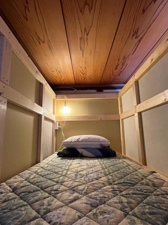 Postel nebo postele na pokoji v ubytování ゲストハウス黒島