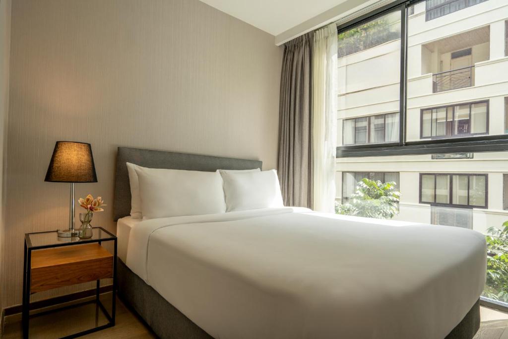 Postel nebo postele na pokoji v ubytování Walton Suites Sukhumvit