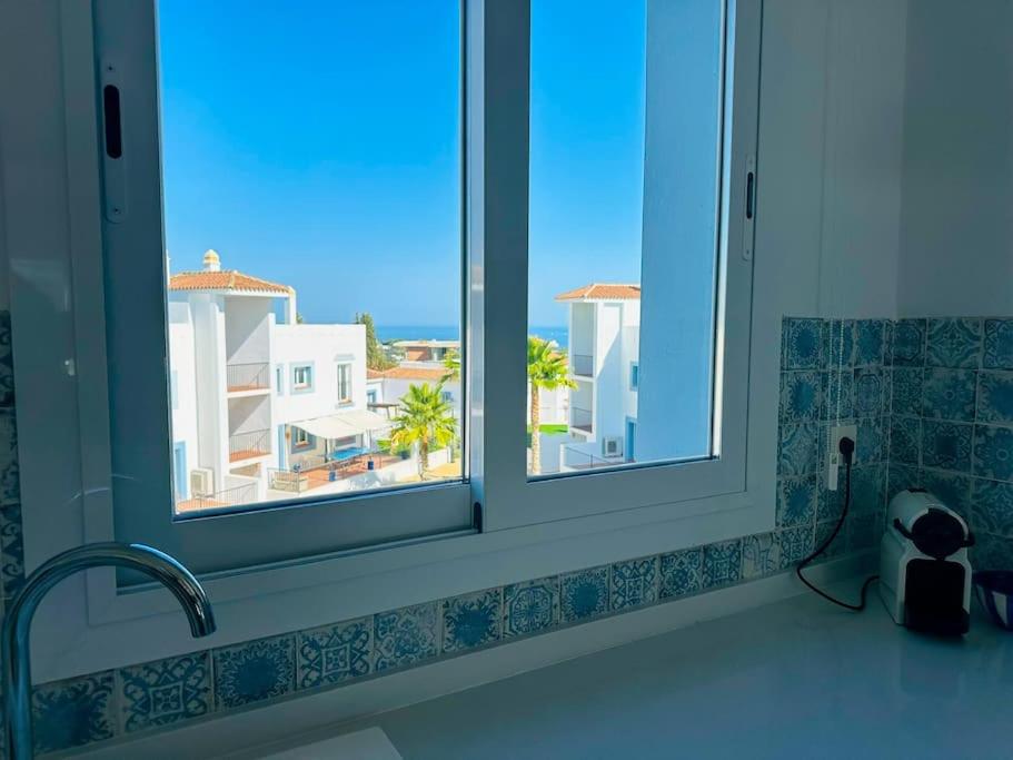 a kitchen window with a view of the ocean at Oceanview luxury Penthouse in Estepona
