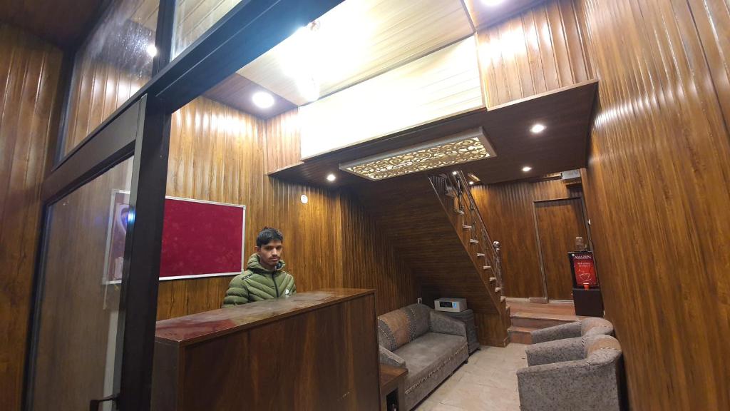 a man standing at a bar in a building at Hotel Townhouse in Rishīkesh