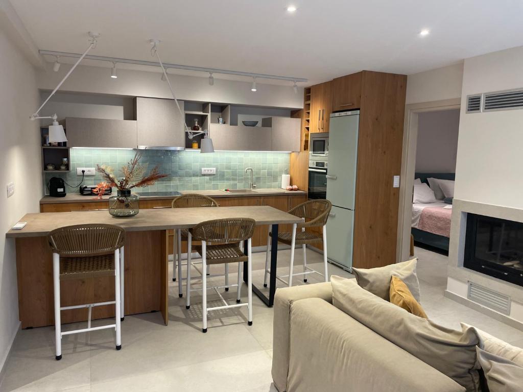 a kitchen and living room with a table and a couch at Casa Argento in Zakynthos Town