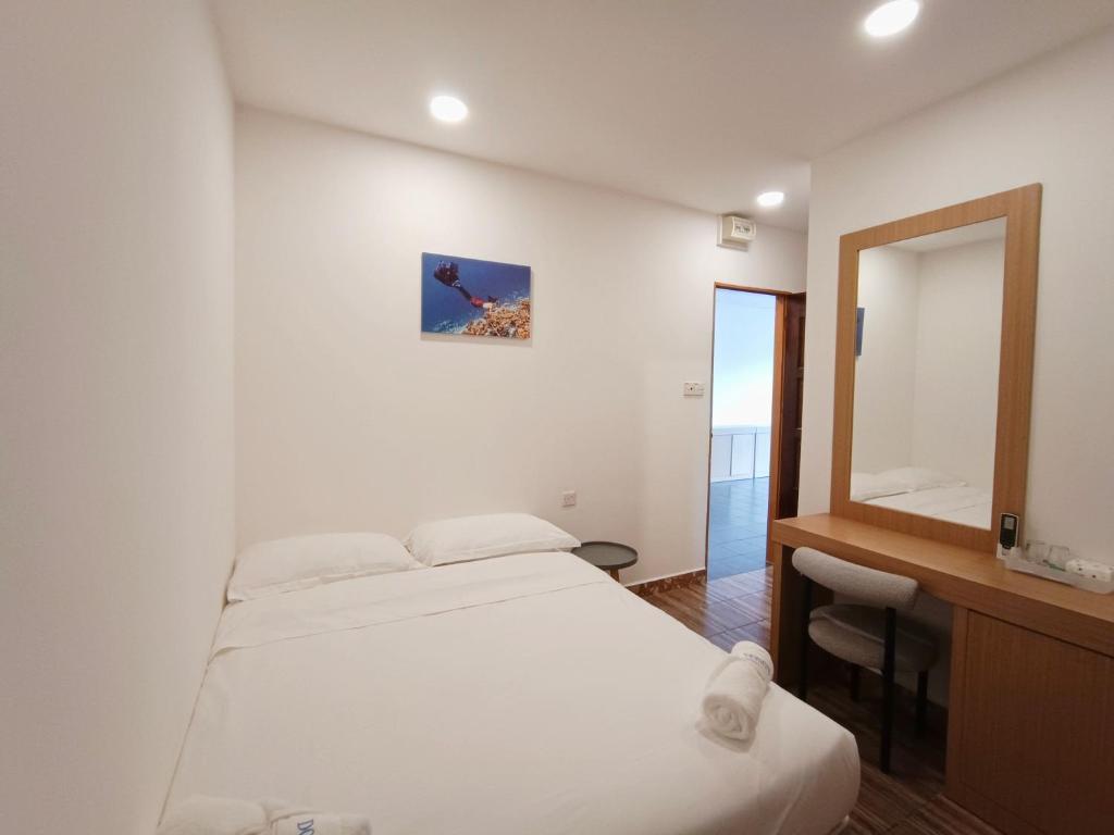 Postel nebo postele na pokoji v ubytování Shoreline Guesthouse 海岸线客栈