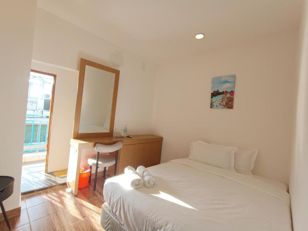 Postel nebo postele na pokoji v ubytování Shoreline Guesthouse 海岸线客栈