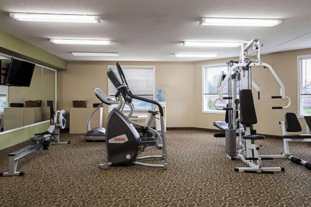 a gym with tread machines and a flat screen tv at Super 8 by Wyndham Sherwood Park/Edmonton Area in Sherwood Park