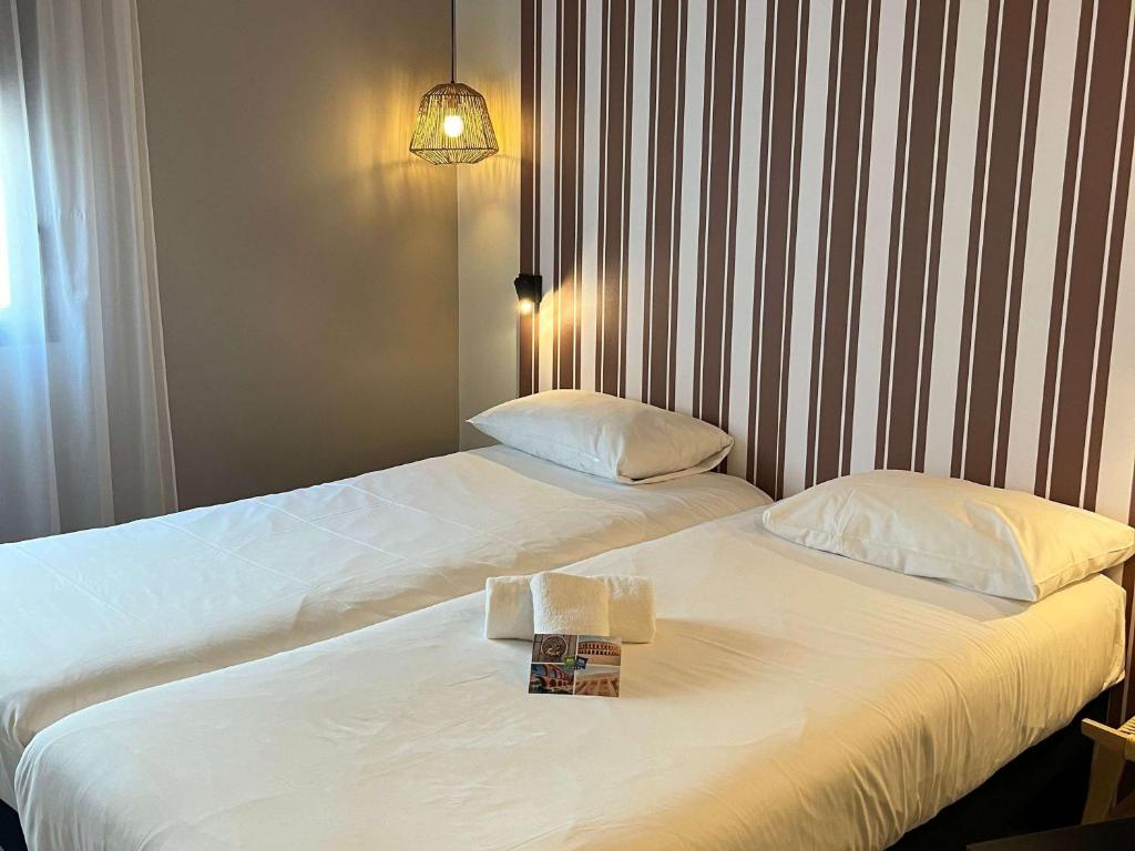 Postel nebo postele na pokoji v ubytování ibis Styles Nimes Gare Centre