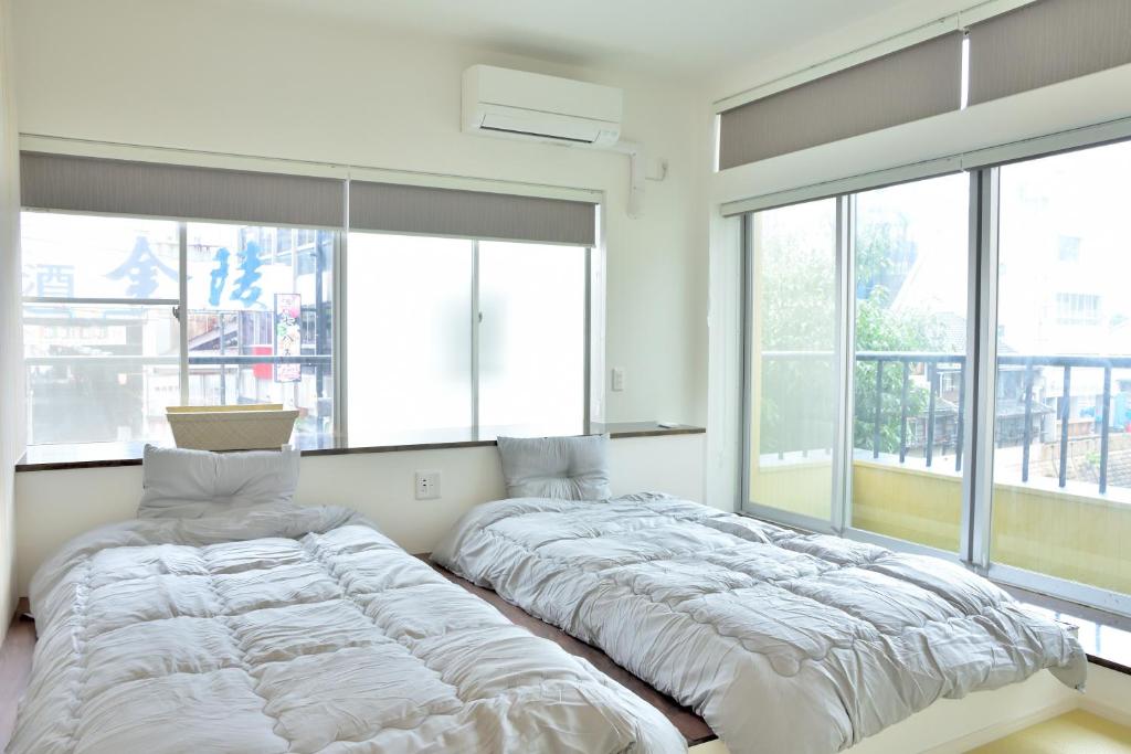 Postel nebo postele na pokoji v ubytování Hostelコトヒラクラスカ