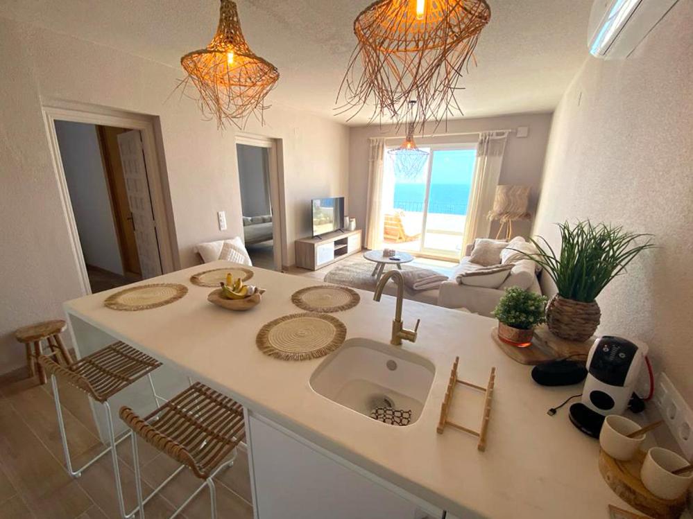 a kitchen with a sink and a living room at Casa Boho in Cumbre del Sol