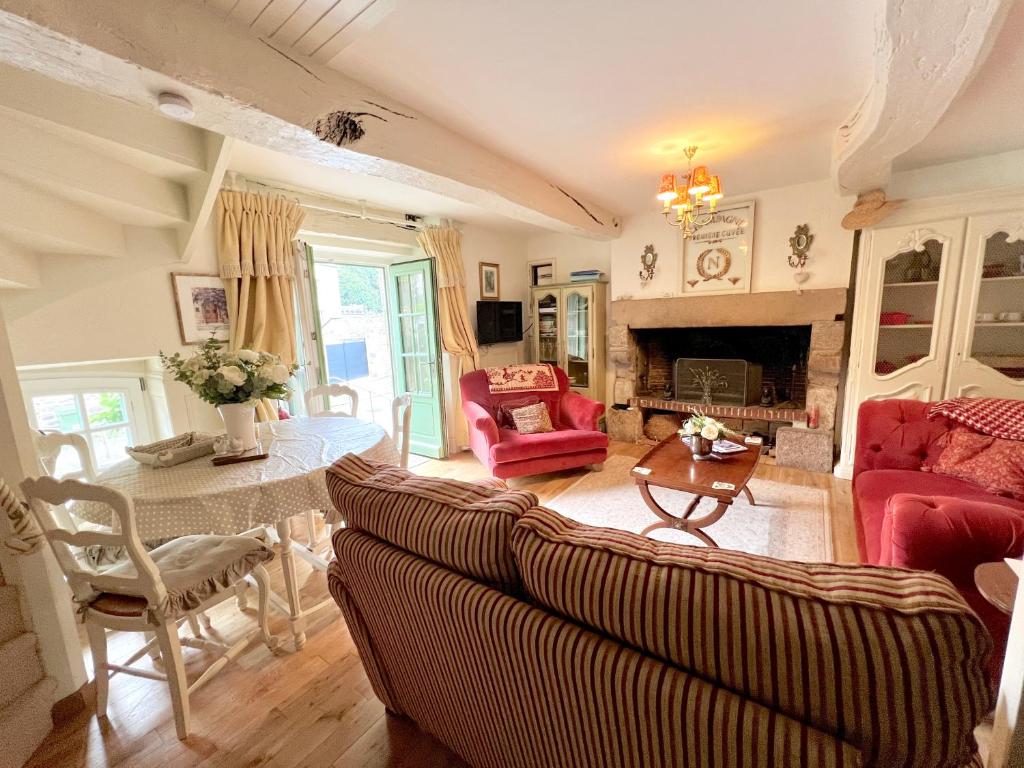 a living room with a couch and a table at La Petite Madeleine is a Charming 2 Bedroom Pet Friendly Gite situated on Dinan Port in Dinan