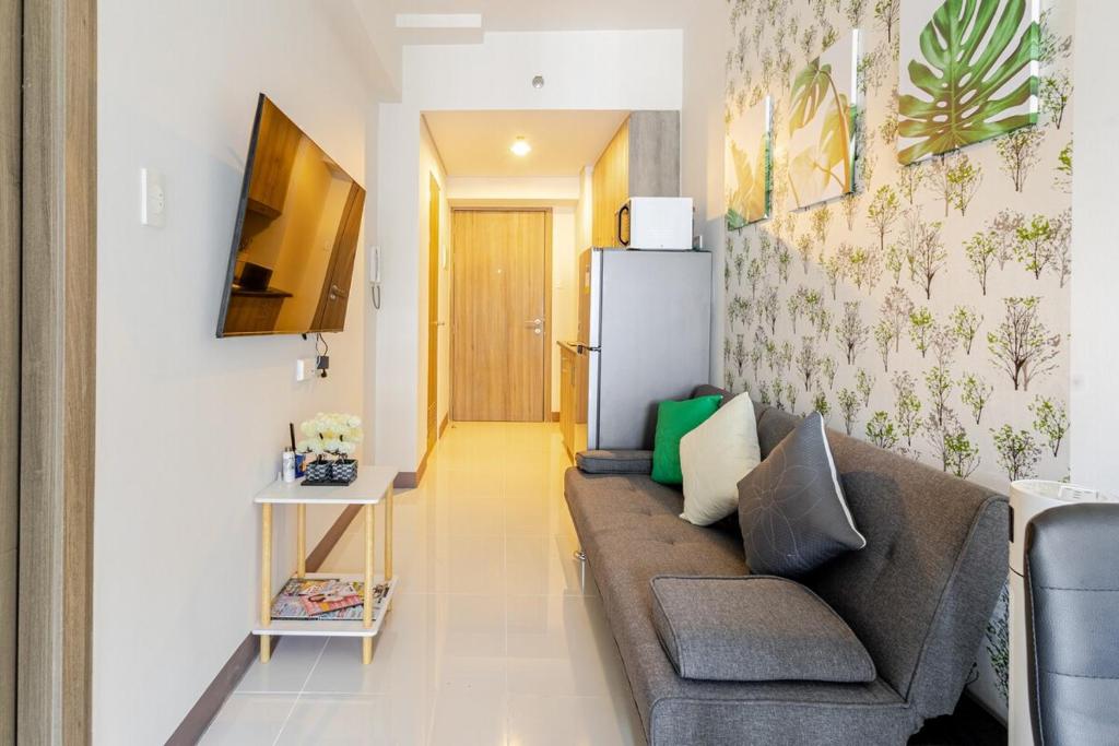 a living room with a couch and a refrigerator at J5 Bayview Elegant Retreat with Stunning Views Free WiFi in Manila