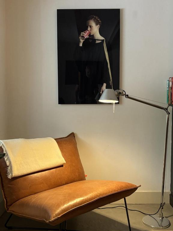 a living room with a lamp and a chair at This Must Be The Place in Utrecht