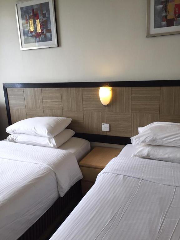 Postel nebo postele na pokoji v ubytování Easy Cozy Simple Room Genting Highlands