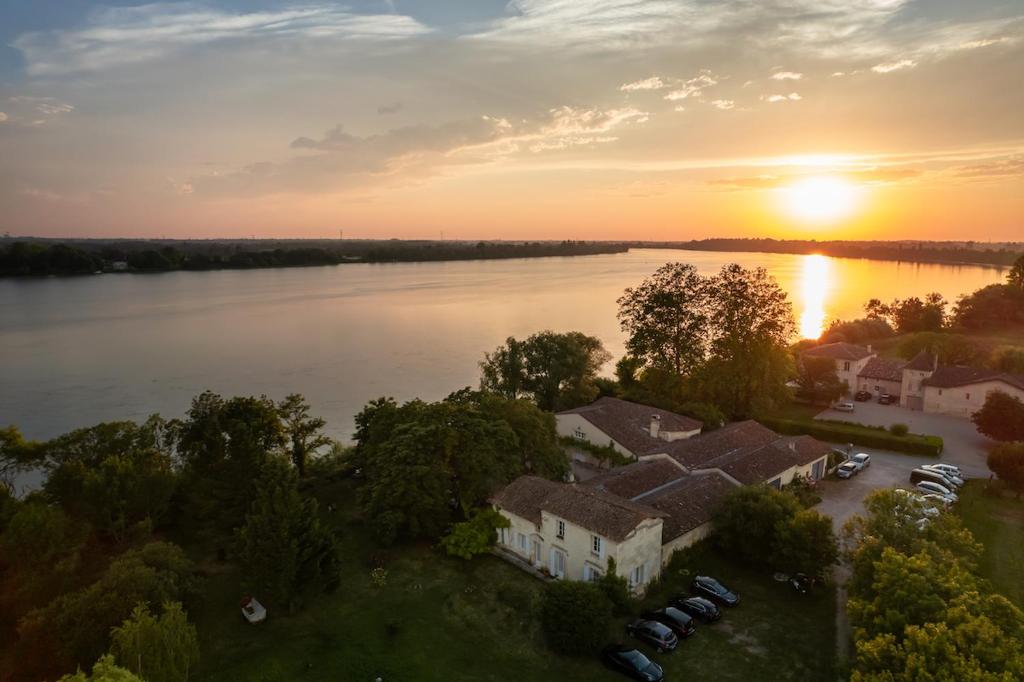 an aerial view of a house next to a river at Chateau de la Vieille Chapelle in Lugon et l’Ile du Carney