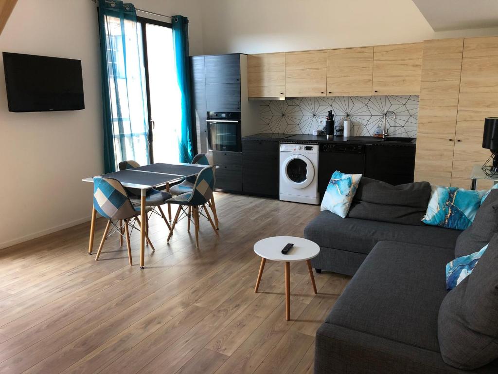 a living room with a couch and a table at Duplex Jaden - 3 pièces climatisé 80m2 in Villeveyrac