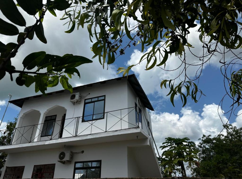 a white building with a sky in the background at paje zanzibar apartment in Paje